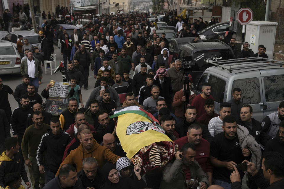 Mourners carry the body of Palestinian Fulla al-Masalmeh,15, during her funeral in the West Bank village of Beit Awwa, Tuesday, Nov. 15, 2022. The Palestinian Health Ministry says Israeli forces shot and killed a 15-year-old Palestinian girl during a pre-dawn raid in the occupied West Bank. The circumstances surrounding the death of the teenage girl in the city of Beitunia in the central West Bank, identified by Palestinian health officials as Fulla al-Masalmeh, were not fully clear. The Israeli military said soldiers opened fire on a vehicle that was accelerating toward them after they signaled for it to stop. The military said it was investigating, and declined to comment further. (AP Photo/Mahmoud Illean)