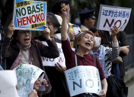 People protesting the planned relocation of the U.S. military base, to Okinawa's Henoko coast, shout slogans at a rally in front of Prime Minister Shinzo Abe's official residence, as a meeting between Okinawa Governor Takeshi Onaga and Abe is holding, in Tokyo April 17, 2015. REUTERS/Issei Kato