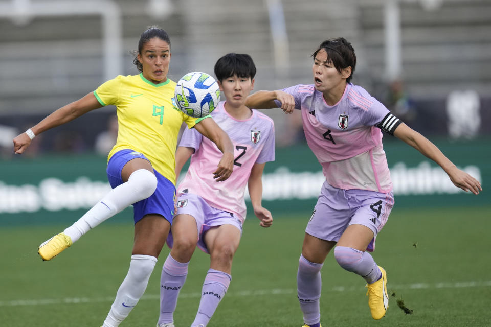 Brazil's Gabi Nunes, left, battles for the ball against Japan's Risa Shimizu, center, and Saki Kumagi ,during a women's friendly soccer match at the Neo Quimica Arena in Sao Paulo, Brazil, Thursday, Nov. 30, 2023. (AP Photo/Andre Penner)