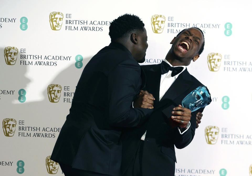 Daniel Kaluuya, left and Micheal Ward react after Ward won the Rising star award, backstage at the Bafta Film Awards, in central London, Sunday, Feb. 2, 2020. (Photo by Joel C Ryan/Invision/AP)