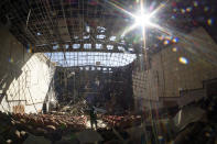 FILE - In this Oct. 13, 2020, file photo, a person stands in a cultural center destroyed by shelling during a military conflict, in Shushi, outside Stepanakert, the capital of the separatist region of Nagorno-Karabakh. A Russian attempt to broker a cease-fire to end the worst outbreak of hostilities over Nagorno-Karabakh in more than a quarter-century has failed to get any traction, with Azerbaijan and Armenia trading blame for new attacks. (AP Photo/File)