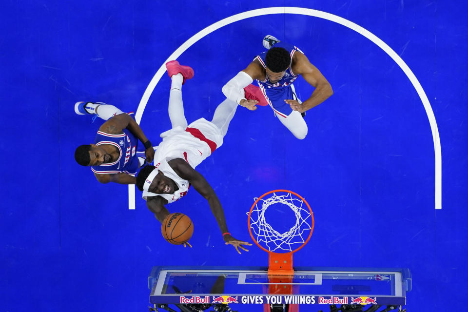 Toronto Raptors' Pascal Siakam, center, goes up for a shot between Philadelphia 76ers' De'Anthony Melton, left, and Tobias Harris during the first half of an NBA basketball game, Thursday, Nov. 2, 2023, in Philadelphia. (AP Photo/Matt Slocum)