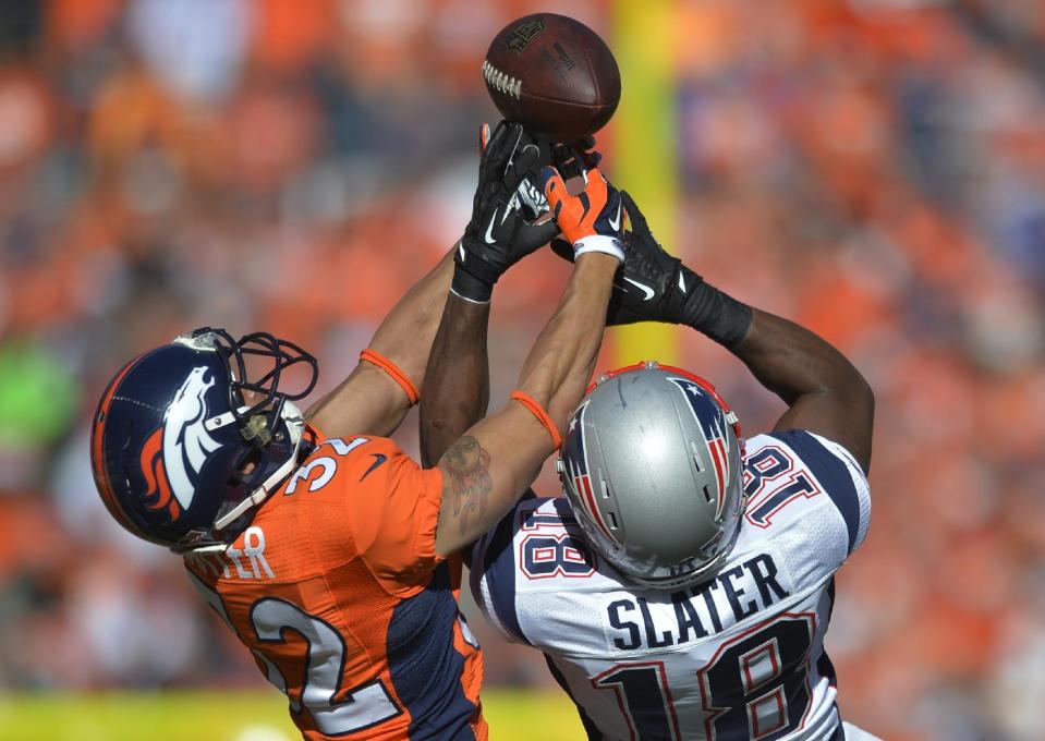 Denver Broncos cornerback Tony Carter (32) breaks up a pass intended for New England Patriots wide receiver Matthew Slater (18) during the first half of the AFC Championship NFL playoff football game in Denver, Sunday, Jan. 19, 2014. (AP Photo/Jack Dempsey)