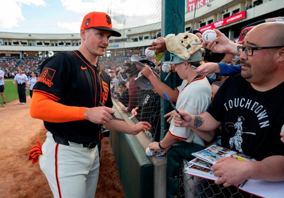 Matt Chapman of the San Francisco Giants signs autographs for fans prior to the game against the Sacramento River Cats on Sunday.