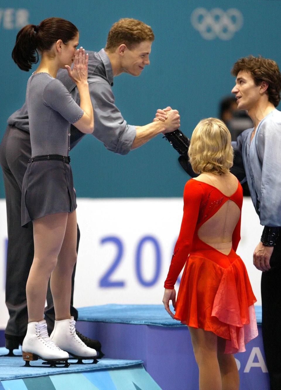 Canadian silver medalists figure skating pair Jamie Sale and David Pelletier, left, congratulate Russian gold medalist Elena Berezhnahya and Anton Sikharulidze on Tuesday, Feb. 12, 2002. | Chuck Wing, Deseret News