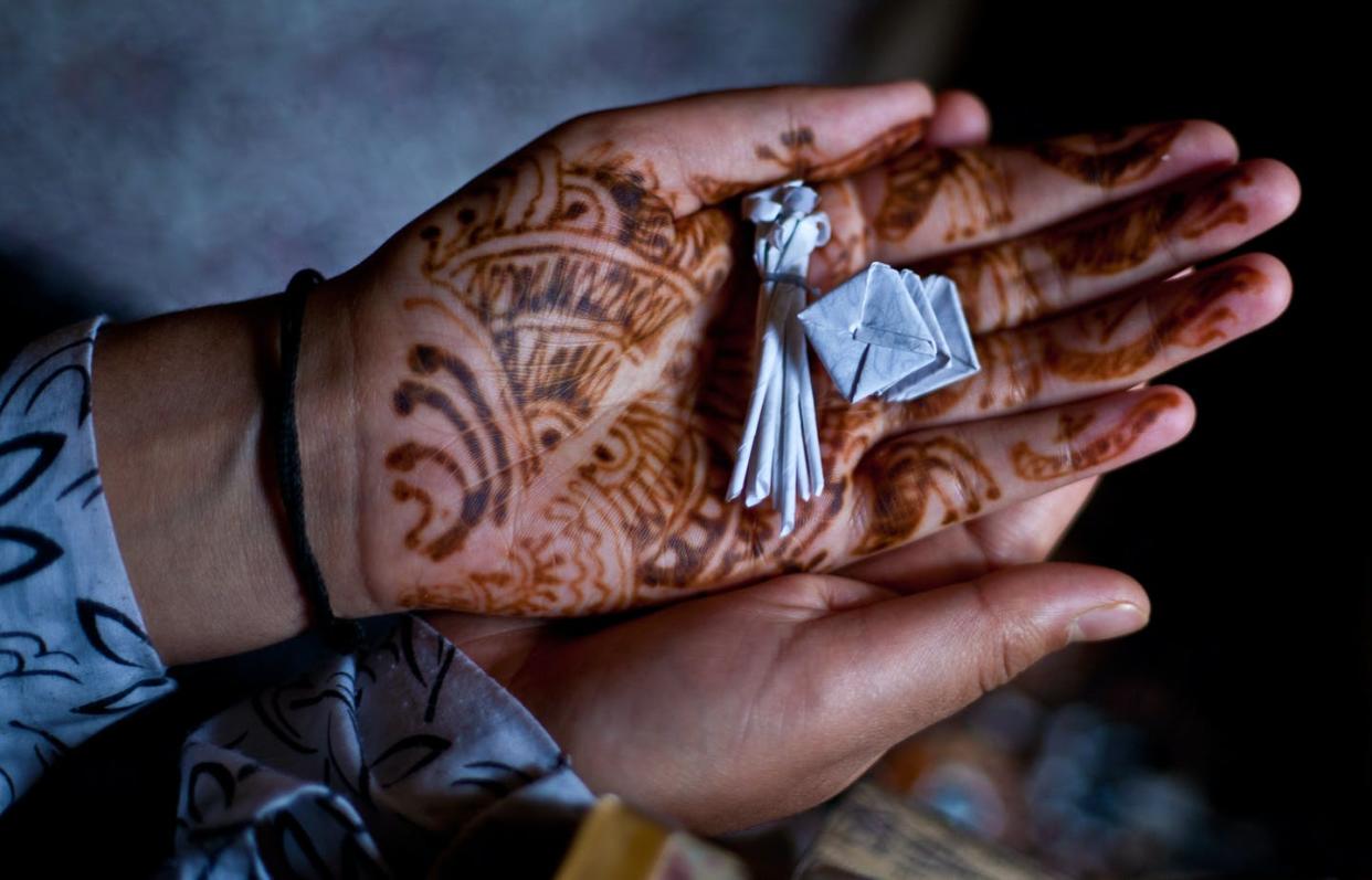 <span class="caption">Faithful in many religions, including Islam, may turn to healing amulets like necklaces and other small objects in difficult times.</span> <span class="attribution"><a class="link " href="https://www.gettyimages.com/detail/news-photo/kashmiri-muslim-woman-hold-amulets-in-her-hands-given-to-news-photo/148191211?adppopup=true" rel="nofollow noopener" target="_blank" data-ylk="slk:Yawar Nazir/Getty Images;elm:context_link;itc:0;sec:content-canvas">Yawar Nazir/Getty Images</a></span>