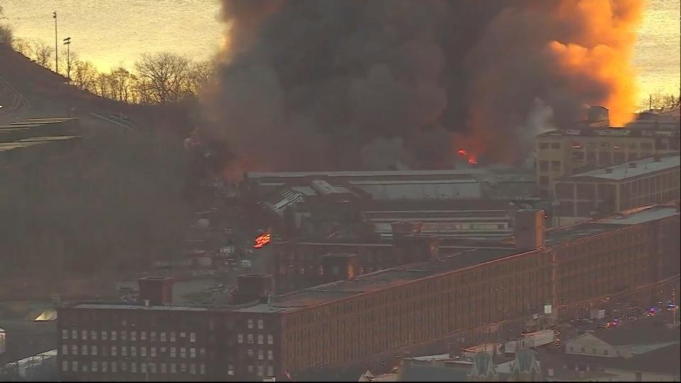 Smoke fills the sky from a fire in Elizabeth, NJ. Firefighters were battling a three-alarm fire at a New Jersey industrial park early Friday, a city official said. (WABC via AP) ORG XMIT: NJTV102