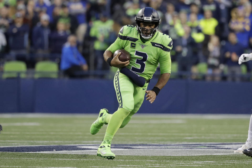 Seattle Seahawks quarterback Russell Wilson carries the ball during the first half of the team's NFL football game against the Los Angeles Rams on Thursday, Oct. 3, 2019, in Seattle. (AP Photo/Elaine Thompson)