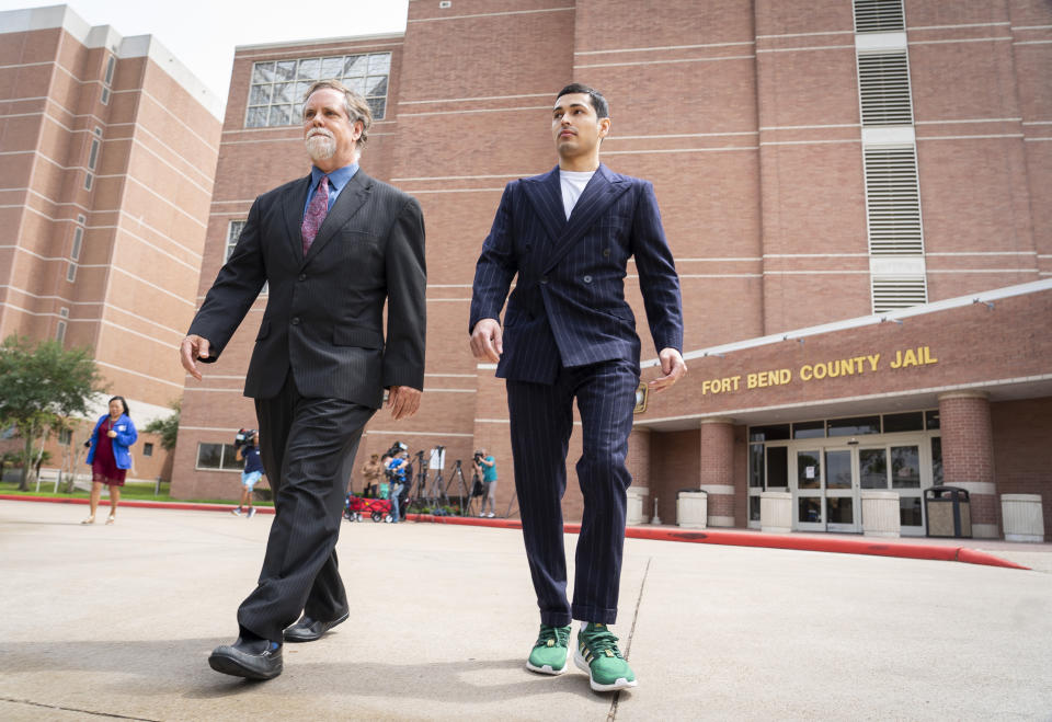 Victor Cuevas, right, walks with his lawyer Michael Elliott after bonding out of jail, Wednesday, May 12, 2021, at the Fort Bend County Jail in Richmond, Texas. Cuevas was arrested Monday after fleeing a Houston Police Officer with a missing tiger in west Houston. Police said Monday that the tiger’s whereabouts are not known. (Mark Mulligan/Houston Chronicle via AP)