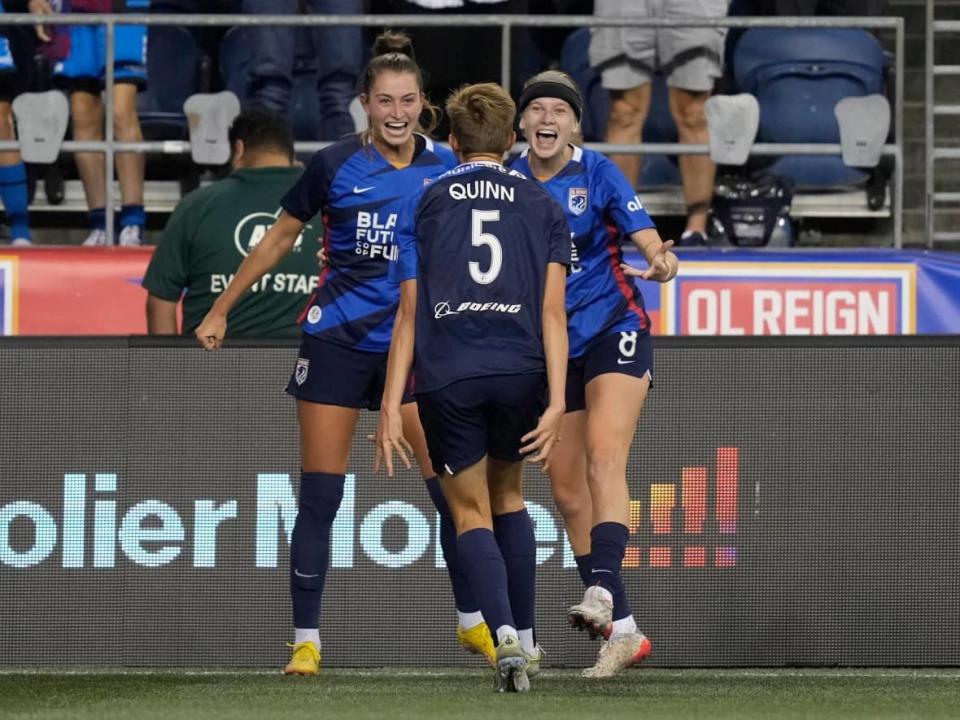 Forward Jordyn Huitema, left, celebrates with fellow Canadian Quinn and OL Reign teammate Bethany Balcer, right, after scoring a goal during Saturday's 3-0 win against the Orlando Pride in Seattle. (Stephen Brashear/USA Today Sports - image credit)