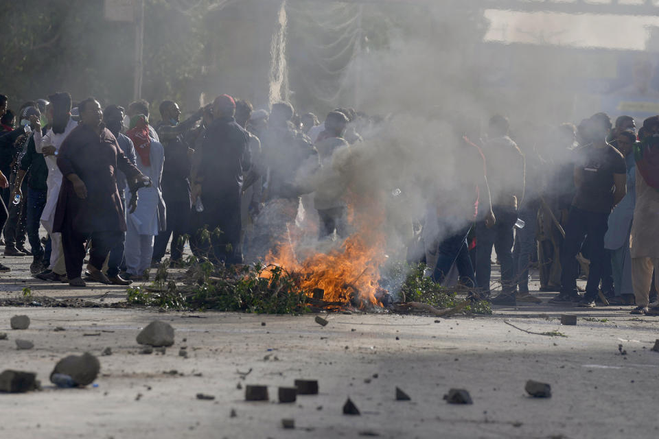 Supporters of Pakistan's former Prime Minister Imran Khan burn tires and other material as they block a road as a protest against the arrest of their leader, in Karachi, Pakistan, Tuesday, May 9, 2023. Khan was arrested Tuesday as he appeared in a court in the country’s capital, Islamabad, to face charges in multiple graft cases. Security agents dragged Khan outside and shoved him into an armored car before whisking him away. (AP Photo/Fareed Khan)