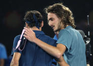 Greece's Stefanos Tsitsipas, right, is congratulated by Switzerland's Roger Federer after winning their fourth round match at the Australian Open tennis championships in Melbourne, Australia, Sunday, Jan. 20, 2019. (AP Photo/Mark Schiefelbein)