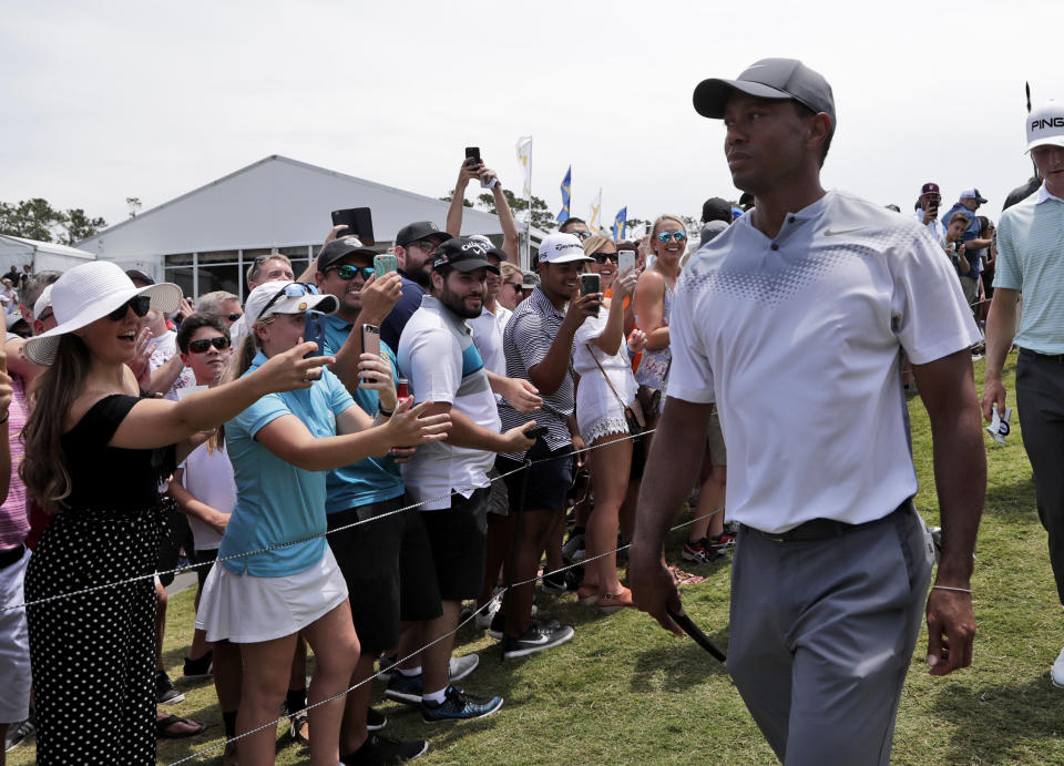 Tiger Woods walks off the 18th hole during the third round of the Players Championship golf tournament. (AP)