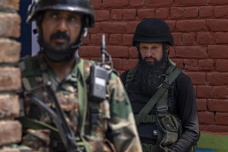 Indian army soldiers stands guard outside the house of their colleague Waseem Sarvar Bhat, who was killed in a gunfight with suspected rebels, in Bandipora, north of Srinagar, Indian controlled Kashmir, Saturday, Aug. 5, 2023. Three Indian soldiers were killed in a gunbattle with rebels fighting against New Delhi's rule in Kashmir, officials said Saturday, as authorities stepped up security on the fourth anniversary since India revoked the disputed region's special status. (AP Photo/Dar Yasin)