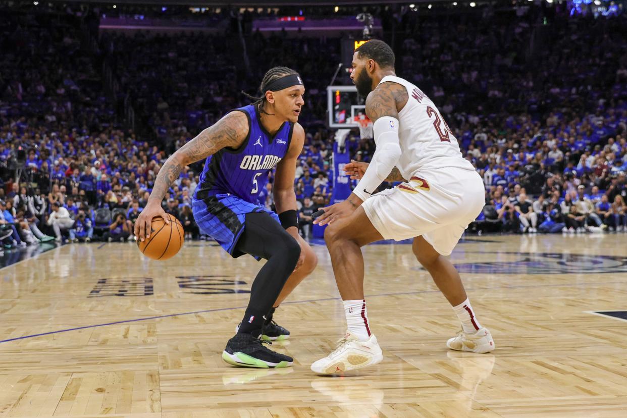 Magic forward Paolo Banchero handles the ball in front of Cavaliers forward Marcus Morris Sr. during the second quarter of Game 6 of a first-round playoff series, May 3, 2024, in Orlando.