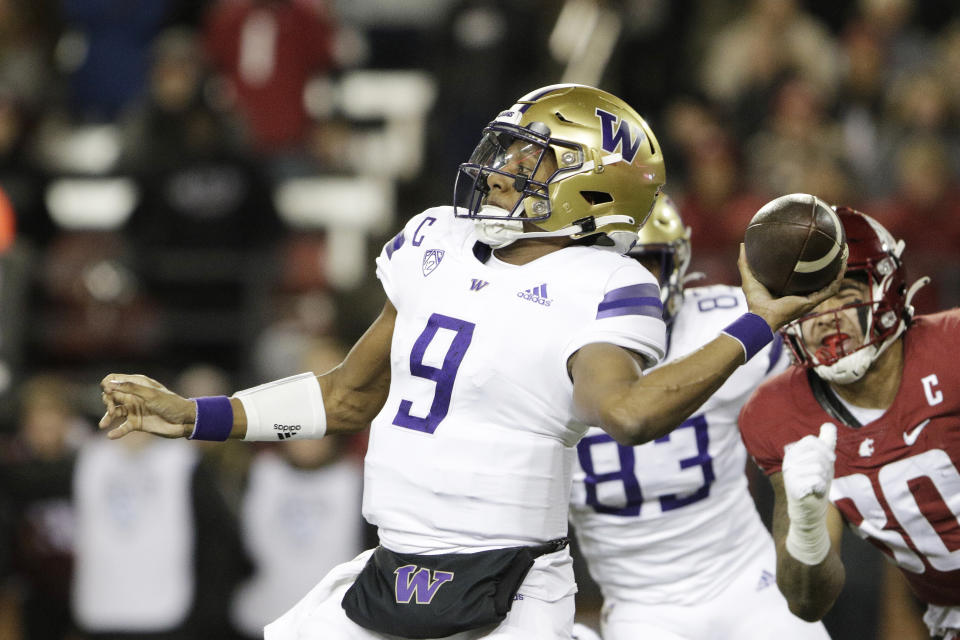 Washington quarterback Michael Penix Jr. (9) throws a pass during the first half of an NCAA college football game against Washington State, Saturday, Nov. 26, 2022, in Pullman, Wash. (AP Photo/Young Kwak)