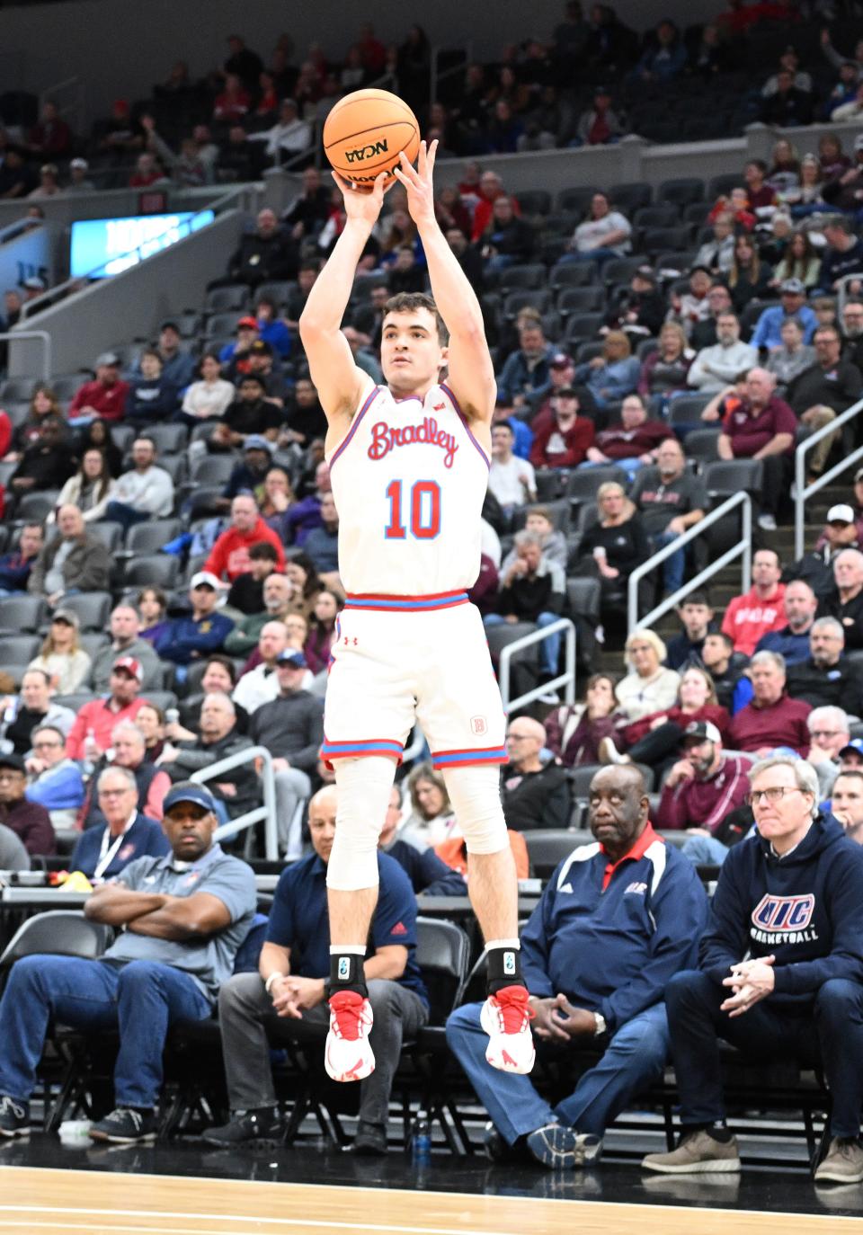 Connor Hickman hits a 3 right in front of the UIC bench during the Braves 74-47 blowout win over UIC in the quarterfinals of the Missouri Valley Conference Tournament at Enterprise Center in St. Louis on Friday, March 8, 2024.