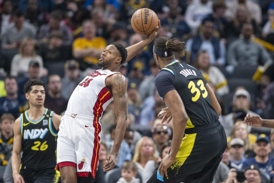 Miami Heat forward Haywood Highsmith (24) grabs a rebound while being defended by Indiana Pacers center Myles Turner (33) during the first half of an NBA basketball game in Indianapolis, Sunday, April 7, 2024. (AP Photo/Doug McSchooler)