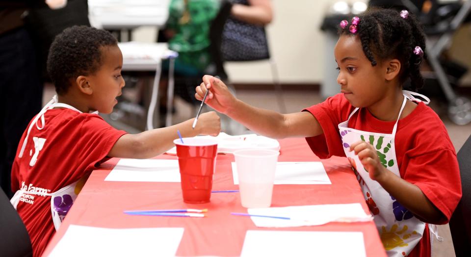 Carson, 5, and Rylee Griffin, 6, of North Canton paint during a Family Art Party at the North Canton Public Library.