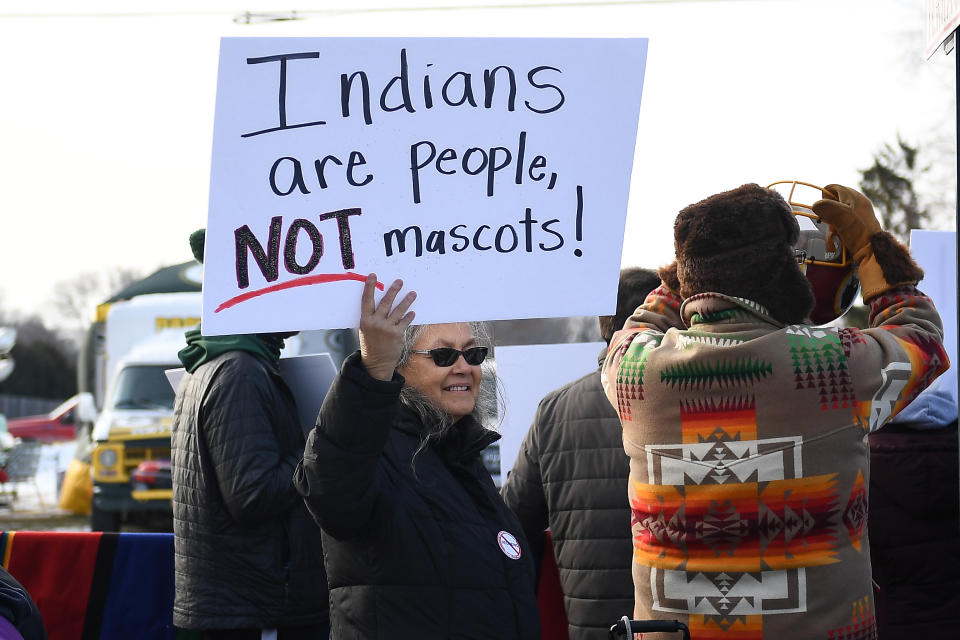 A woman demonstrates against the Washington team name outside a game in Green Bay, Wisconsin, in 2019. The franchise has often faced protests outside road games, especially as pressure to change its name intensified again over the last decade. (Photo: Stacy Revere via Getty Images)