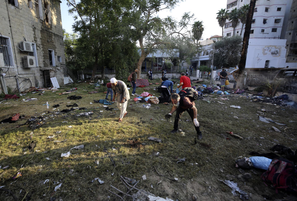 Palestinians check the site of a deadly explosion in al-Ahli hospital, in Gaza City, Wednesday, Oct. 18, 2023. The Hamas-run Health Ministry says an Israeli airstrike caused the explosion that killed hundreds at al-Ahli, but the Israeli military says it was a misfired Palestinian rocket. (AP Photo/Abed Khaled)