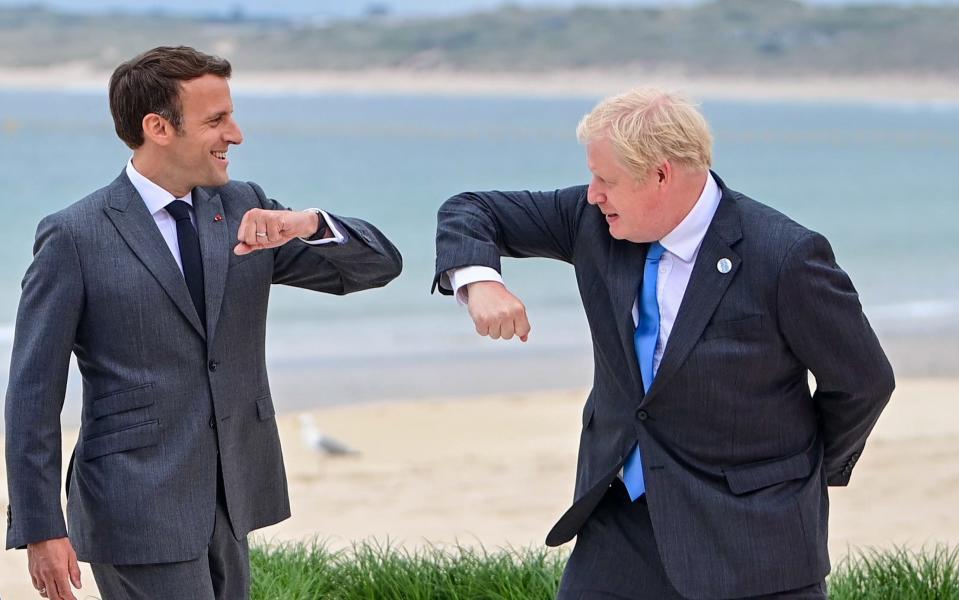French President Emmanuel Macron elbow bumps with British Prime Minister Boris Johnson on the first day of the G7 leaders summit in Carbis Bay - Neil Hall /EPA