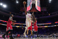 Philadelphia 76ers' Joel Embiid, left, goes up for a shot against Chicago Bulls' Patrick Beverley in overtime of an NBA basketball game, Monday, March 20, 2023, in Philadelphia. (AP Photo/Matt Slocum)