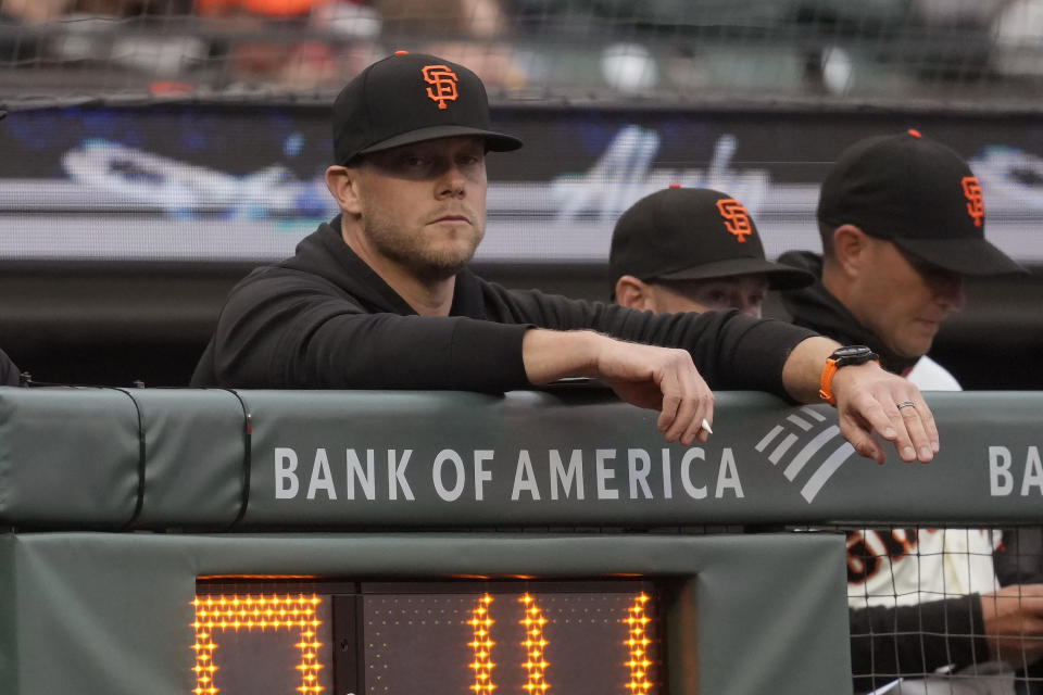 FILE -San Francisco Giants pitching coach Andrew Bailey, left, watches from over the pitch clock during a baseball game against the Los Angeles Dodgers in San Francisco, Monday, April 10, 2023. Bailey was hired Tuesday, Nov. 21, as pitching coach of the Boston Red Sox after four seasons in the same role with the Giants.(AP Photo/Jeff Chiu, File)