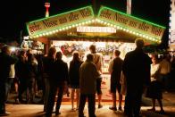 A booth selling fried nuts attracts people at the Oktoberfest.