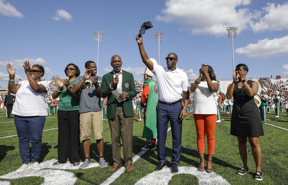 The Gillums stand with other FAMU alumni during the homecoming football game coin toss. (Photo: Willie J. Allen Jr. for HuffPost)