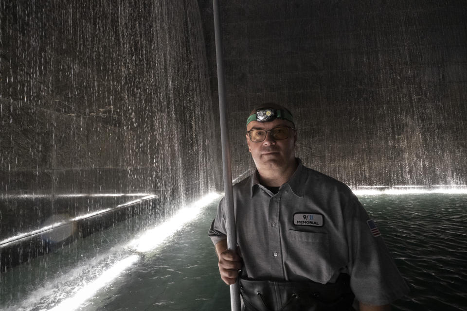 James Maroon, an engineer at the 9/11 Memorial, poses near the waterfalls in the south pool, Wednesday, Aug. 4, 2021 in New York. On Sept. 11, 2001 he was going to work at the New York Mercantile Exchange, just west of the World Trade Center. He knew about 20 brokers at Cantor Fitzgerald that worked at the exchange. "They had a meeting that morning in one of the towers," he recalled. All their brokers, except for one, perished that day. Sometimes when we're outside I look at the panel that their names are on. And one of them Elkin Yuen, his daughter was due to be born. Now she's going to be 20 years old. And never met her father." (AP Photo/Mark Lennihan)