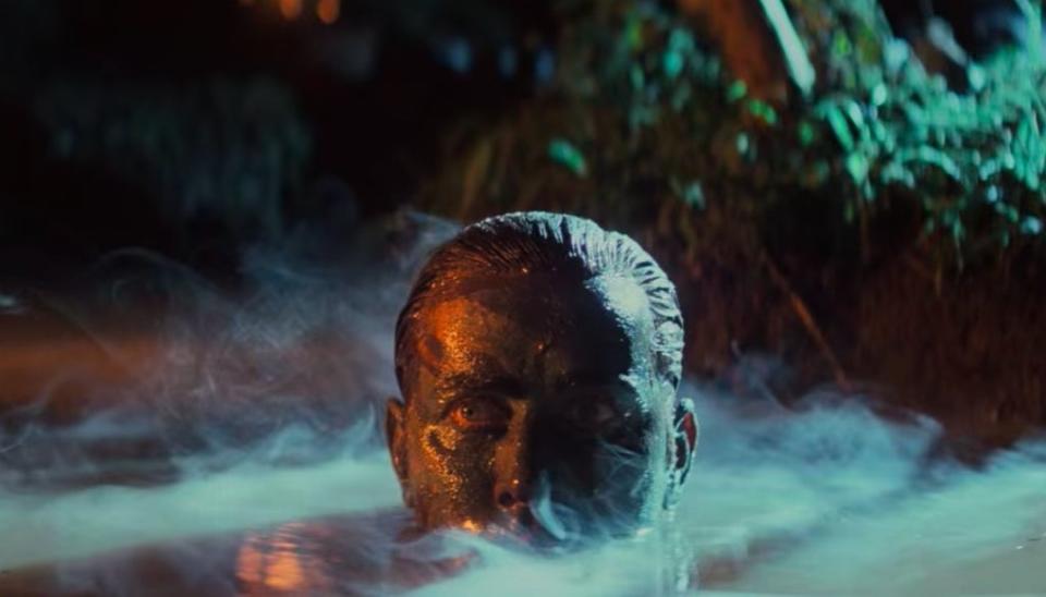 Willard rising out of the river with mud on his face in "Apocalypse Now Redux"