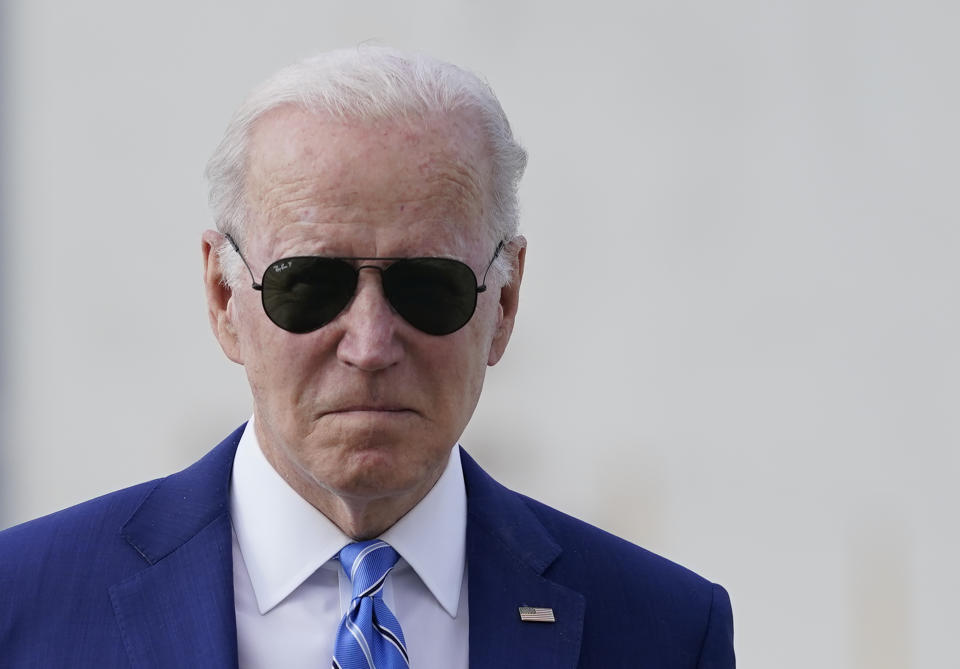 FILE - President Joe Biden walks across the tarmac to speak to the media before boarding Air Force One at Des Moines International Airport, in Des Moines Iowa, April 12, 2022, en route to Washington. Biden said that Russia's war in Ukraine amounted to a "genocide," accusing President Vladimir Putin of trying to "wipe out the idea of even being a Ukrainian." The Biden administration has for weeks grappled with how much intelligence it's willing to give Ukrainian forces trying to stop Putin. (AP Photo/Carolyn Kaster, File)