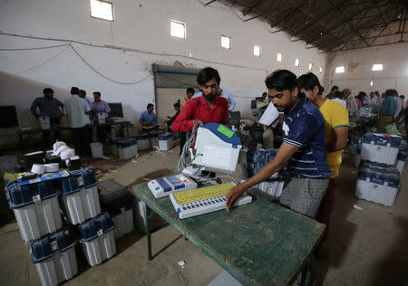 FILE PHOTO: Election staff check Voter Verifiable Paper Audit Trail (VVPAT) machines and Electronic Voting Machines (EVM) ahead of India's general election at a warehouse in Ahmedabad, India, March 6, 2019. REUTERS/Amit Dave/File Photo