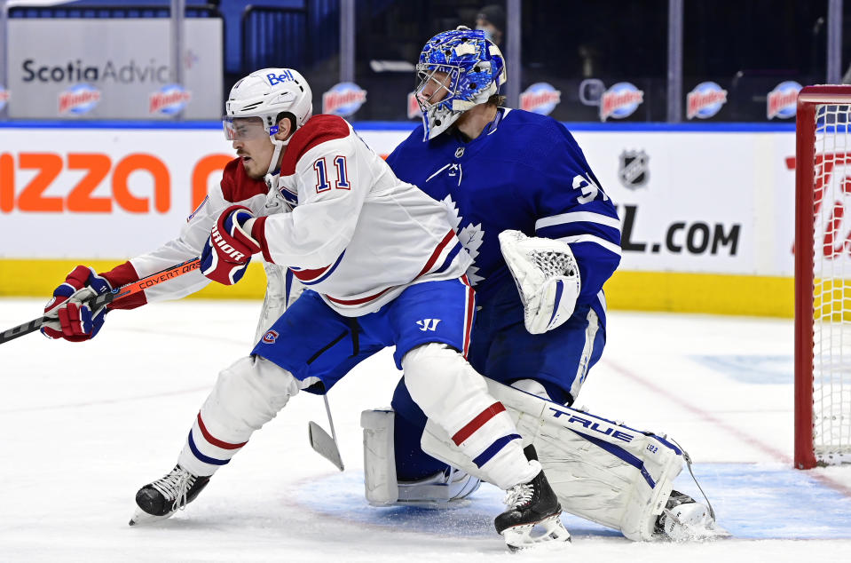 Toronto Maple Leafs goaltender Frederik Andersen (31) looks for the puck as Montreal Canadiens right wing Brendan Gallagher (11) blocks his view during the first period of an NHL hockey game in Toronto on Saturday, Feb. 13, 2021. (Frank Gunn/The Canadian Press via AP)