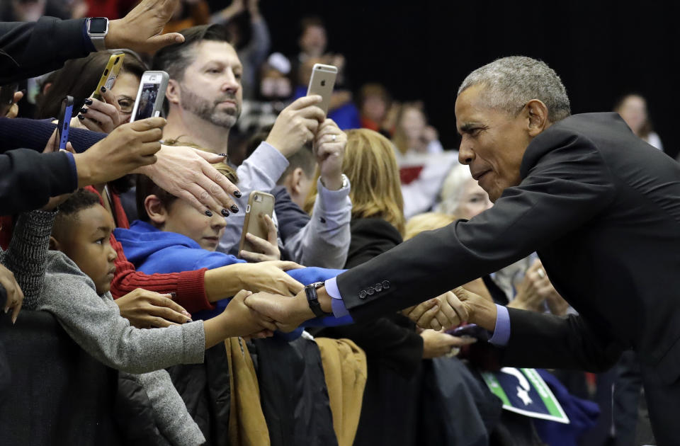 Former President Barack Obama, right, greets Democratic supporters at Genesis Convention Center, Sunday, Nov. 4, 2018, in Gary, Ind. Obama rallied Democrats on behalf of Sen. Joe Donnelly, D-Ind., who faces a stiff challenge from Republican businessman Mike Braun. (AP Photo/Nam Y. Huh)