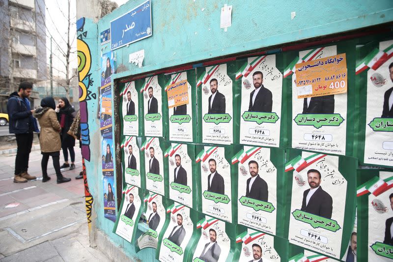 Parliamentary election campaign posters are seen in Tehran