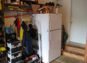 A white fridge in a garage