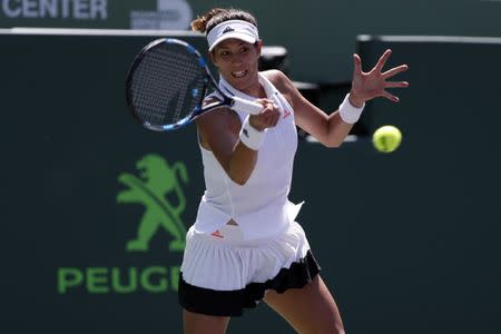 Mar 27, 2017; Miami, FL, USA; Garbine Muguruza of Spain hits a forehand against Caroline Wozniacki of Denmark (not pictured) on day seven of the 2017 Miami Open at Crandon Park Tennis Center. Mandatory Credit: Geoff Burke-USA TODAY Sports