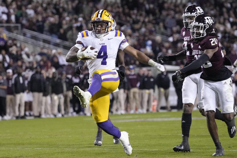 LSU running back John Emery Jr. (4) high-kicks into the end zone for a touchdown against Texas A&M during the second half of an NCAA college football game Saturday, Nov. 26, 2022, in College Station, Texas. (AP Photo/Sam Craft)