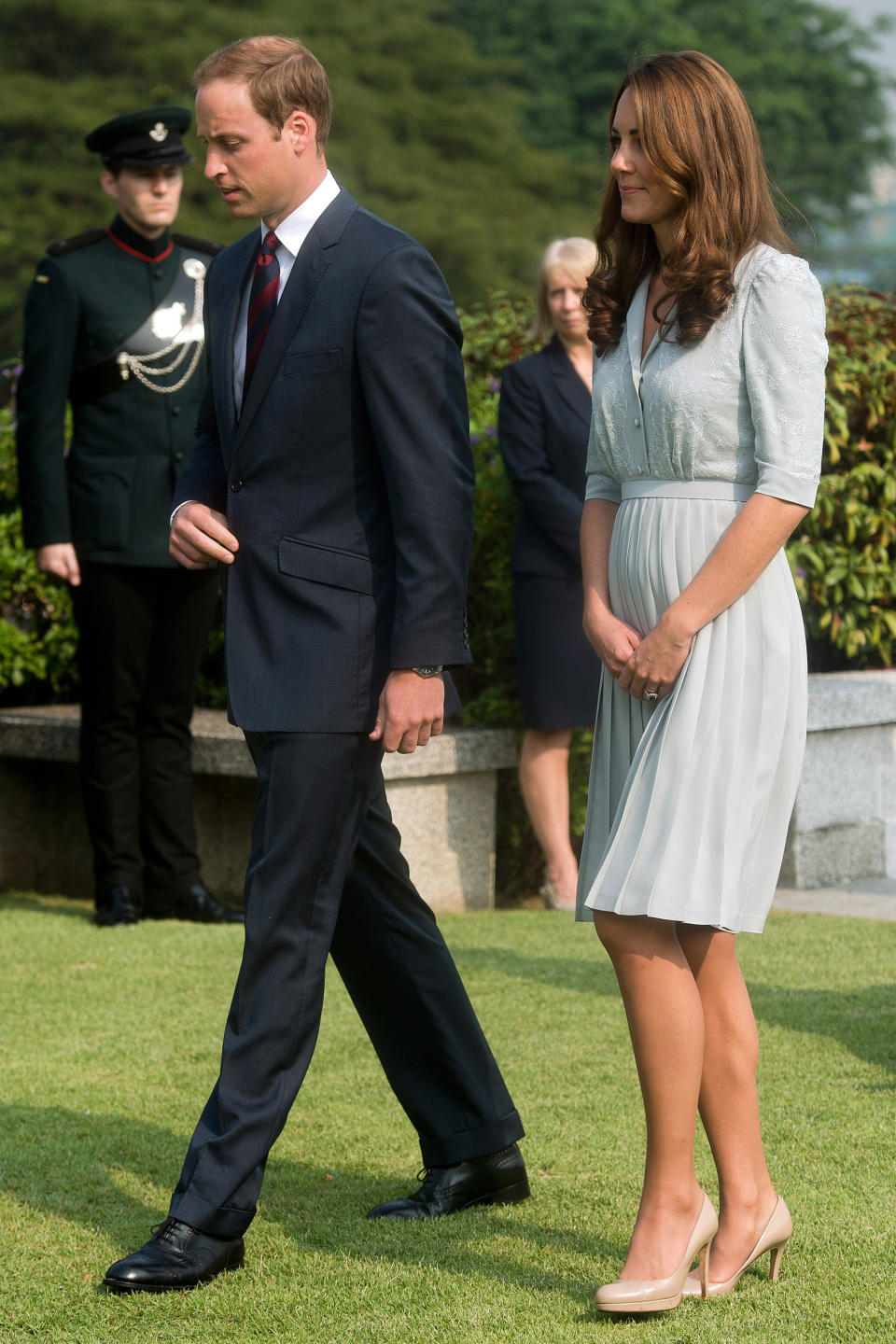 FILE - In this Thursday, Sept. 13, 2012 file photo, Britain's Prince William and his wife Kate, the Duke and Duchess of Cambridge, walk together as they visit the Kranji Commonwealth War Memorial in Singapore. Prince William and his wife Catherine are expecting their first child. St. James’s Palace announced the pregnancy Monday, saying that the Duchess of Cambridge, formerly known as Kate Middleton has a severe form of morning sickness and is currently in a London hospital. William is at his wife’s side. (AP Photo/Nicolas Asfouri, Pool, File)