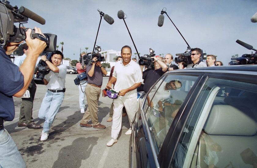 O.J. Simpson is surrounded by media as he departs Santa Monica Superior Court in Santa Monica, California on Thursday, May 15, 1997. (AP Photo/Nick Ut)