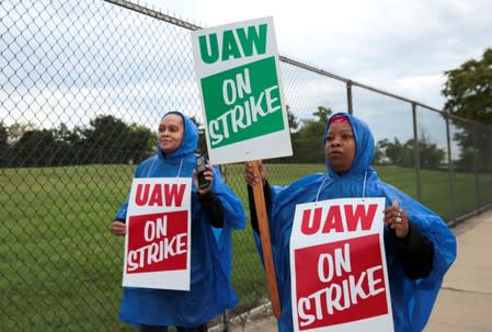 United Auto Workers, Aramark workers carry strike signs while picketing outside the General Motors Detroit-Hamtramck assembly plant in Detroit,