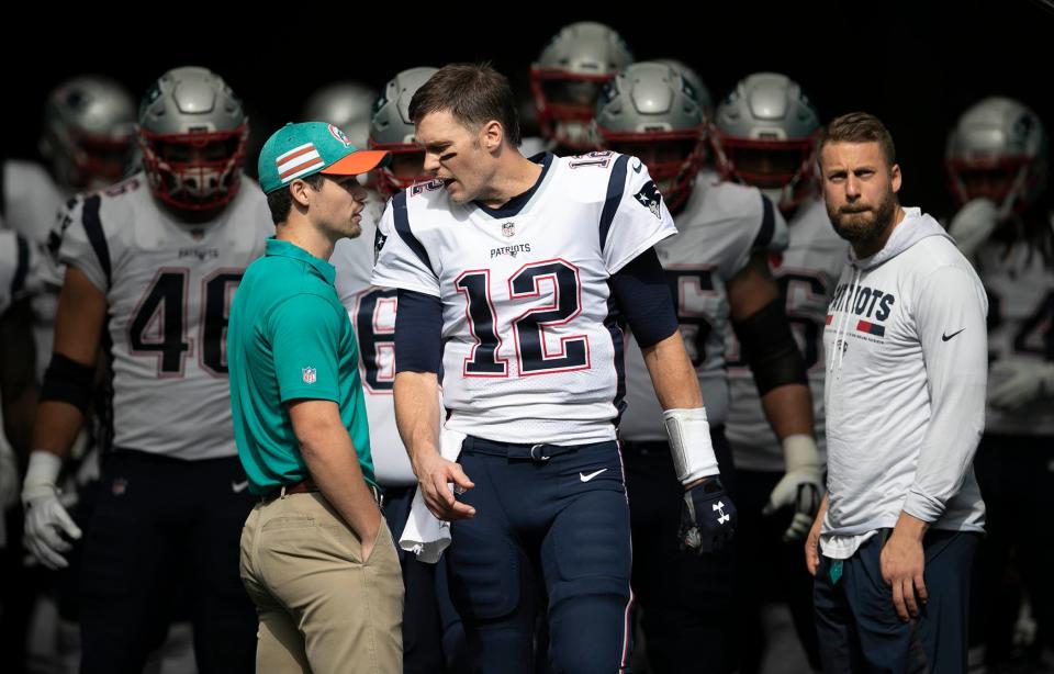 Might Tom Brady, here leading the Patriots out of the tunnel before a game against the Dolphins at Hard Rock Stadium in 2018, still lead Miami out the tunnel some day?