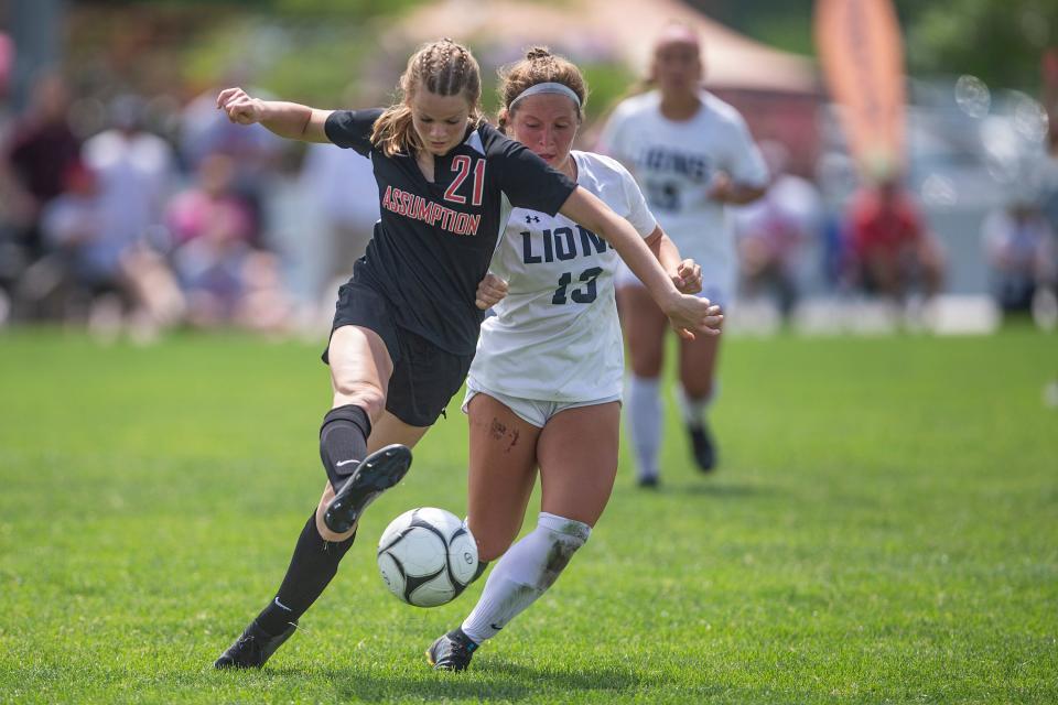 Davenport Assumption's Morgan Jennings kicks the ball away from Des Moines Christian's Isabel Garcia during the Class 1A girls state soccer championship, on Saturday, June 4, 2022, at the Cownie Soccer Complex, in Des Moines. Des Moines Christian won the title match, 1-0. 