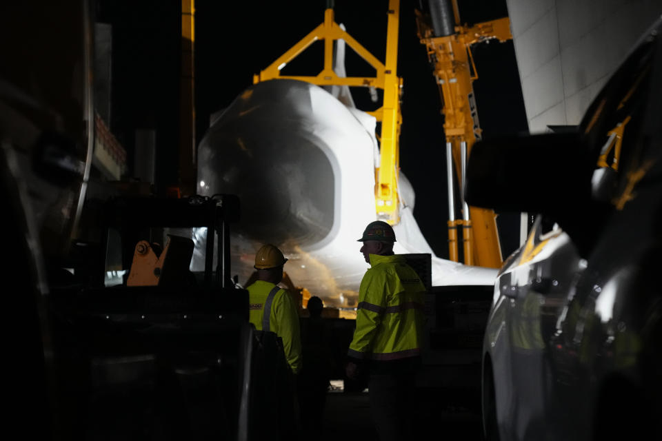 Crews prepare to lift Space Shuttle Endeavour into the site of the future Samuel Oschin Air and Space Center on Monday, Jan. 29, 2024, in Los Angeles. (AP Photo/Ashley Landis)