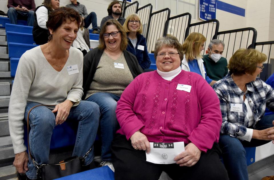 Cindy Bowman, Betsy Bronson and Pat Rigel, swimmers at Dundee High School in 1972-73, laugh with one another Tuesday while wearing name tags with their maiden names as they were recognized this week for playing sports when Title IX was implemented. Behind is Janice Juckette.