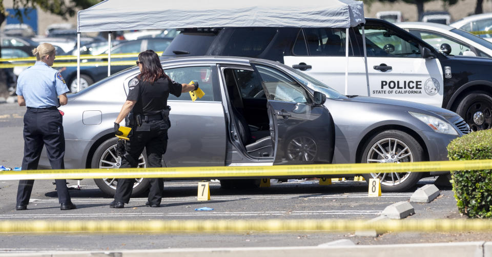 Police investigate a car where a retired Cal State Fullerton administrator was stabbed to death Monday, August 19, 2019 in Fullerton, Calif. The stabbing happened in Parking Lot S at College Place and Langsdorf Drive in Fullerton. (Paul Bersebach/The Orange County Register via AP)
