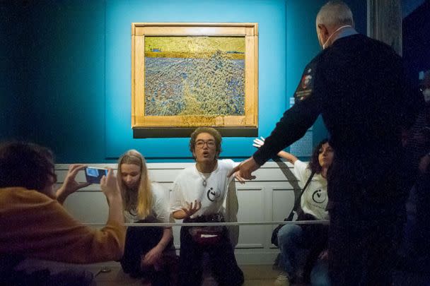 PHOTO: Protesters from the action group Ultima Generazione glue themselves to a wall after throwing soup on Vincent Van Gogh's painting 'Sower at Sunset' as they stage an Ecoclimate protest, Nov. 4, 2022, in Rome, Italy. (Laura Lezza/Getty Images)