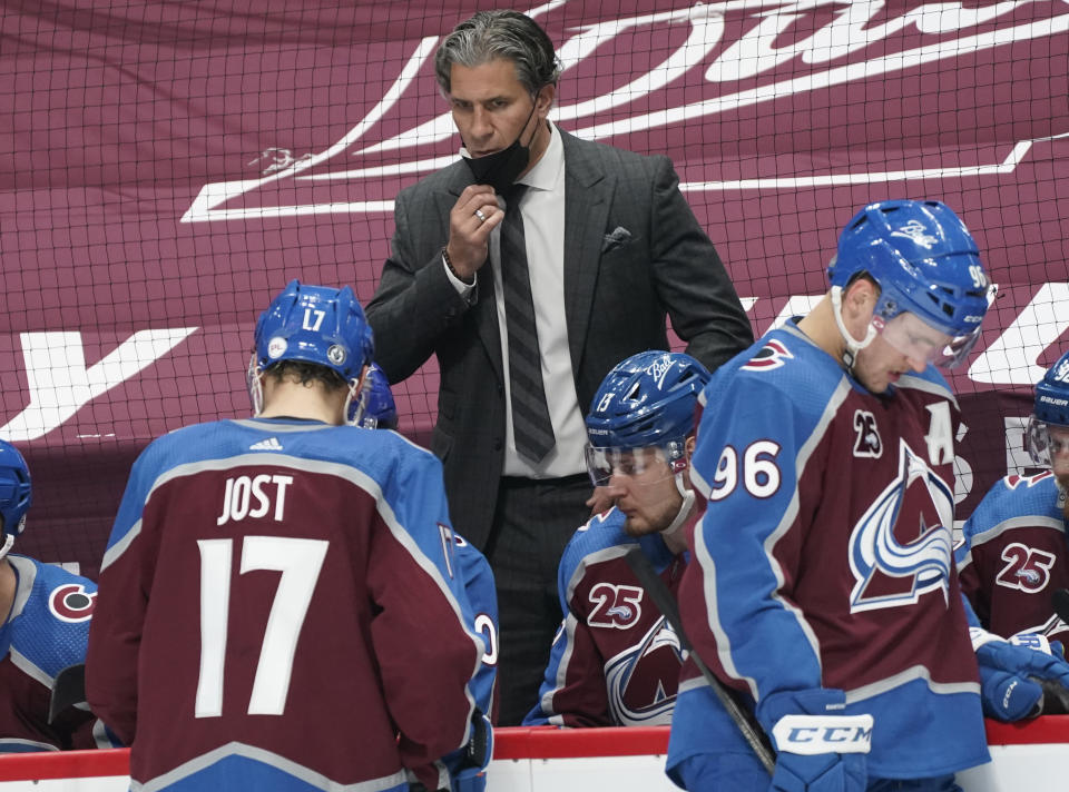 Colorado Avalanche head coach Jared Bednar, top, directs his players during a timeout against the St. Louis Blues in the second period of Game 1 of an NHL hockey Stanley Cup first-round playoff series Monday, May 17, 2021, in Denver. (AP Photo/David Zalubowski)
